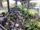 Unique sunroom waterfall feature showcases rock detailing, lush plants, and whimsical accents at 31258 Park Ridge Dr, Brooksville, FL 34602