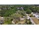 Aerial perspective of a home and its surroundings, blending with nature at 38327 Palm Grove Dr, Zephyrhills, FL 33542