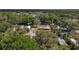 Scenic aerial shot of a house nestled in a tree filled neighborhood at 38327 Palm Grove Dr, Zephyrhills, FL 33542