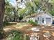 Backyard featuring mature trees and landscaping at 38327 Palm Grove Dr, Zephyrhills, FL 33542