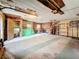 Unfinished basement with concrete floors, exposed ceiling, and shelves at 38327 Palm Grove Dr, Zephyrhills, FL 33542