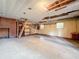 Unfinished basement with concrete floors and exposed ceiling at 38327 Palm Grove Dr, Zephyrhills, FL 33542