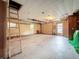 Unfinished basement with garage door, concrete floor, and exposed ceiling at 38327 Palm Grove Dr, Zephyrhills, FL 33542