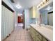 Bathroom with a long pale green vanity and light blue shower curtain at 38327 Palm Grove Dr, Zephyrhills, FL 33542