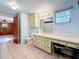 Bathroom featuring a green vanity, a stool, and light blue walls at 38327 Palm Grove Dr, Zephyrhills, FL 33542