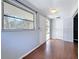 Bright entryway with wood-look flooring, light gray walls, and a view of the front yard at 38327 Palm Grove Dr, Zephyrhills, FL 33542