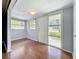 Inviting entryway featuring wood-look flooring, gray walls, and a bright front door with windows at 38327 Palm Grove Dr, Zephyrhills, FL 33542