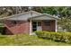 Up close view of the brick house with a trimmed lawn and white door at 38327 Palm Grove Dr, Zephyrhills, FL 33542