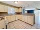 Open floor plan kitchen with tile floors, gas range, and lots of cabinets at 38327 Palm Grove Dr, Zephyrhills, FL 33542