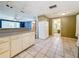 Kitchen space shows view to living space; tile floor and lots of cabinets at 38327 Palm Grove Dr, Zephyrhills, FL 33542