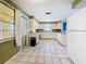 Spacious kitchen features tile floor, window, and appliances; lots of room at 38327 Palm Grove Dr, Zephyrhills, FL 33542