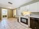 Kitchen featuring window, tile floor, gas range, and view to bathroom at 38327 Palm Grove Dr, Zephyrhills, FL 33542