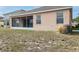 View of the home's backyard with the screened in porch and grass at 416 Durham Shore Ct, Apollo Beach, FL 33572