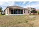 Spacious backyard featuring a screened-in porch, fire pit, and well-maintained lawn at 416 Durham Shore Ct, Apollo Beach, FL 33572