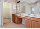 Bathroom with double sink vanity, large mirror and walk in closet at 416 Durham Shore Ct, Apollo Beach, FL 33572