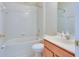 Well-lit bathroom with a combined tub and shower and a vanity with storage at 416 Durham Shore Ct, Apollo Beach, FL 33572