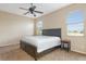 Bedroom featuring a king bed, ceiling fan, and two windows offering natural light and a serene view of the outdoors at 416 Durham Shore Ct, Apollo Beach, FL 33572