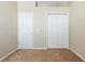 A standard bedroom with beige carpet flooring, closet and door at 416 Durham Shore Ct, Apollo Beach, FL 33572