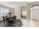 Bright dining room with a view of the office and front door, featuring dark wood floors at 416 Durham Shore Ct, Apollo Beach, FL 33572