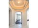 Elegant foyer features a decorative ceiling with recessed lighting and arched entryways leading to other rooms at 416 Durham Shore Ct, Apollo Beach, FL 33572