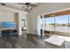 Spacious living room with wood floors, vaulted ceilings, and sliding doors leading to a screened patio with a water view at 416 Durham Shore Ct, Apollo Beach, FL 33572