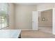 Home office featuring a window with blinds, a modern desk, and an open doorway on neutral carpet at 416 Durham Shore Ct, Apollo Beach, FL 33572