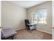 Home office featuring a window with blinds, a modern desk, and a comfortable chair on neutral carpet at 416 Durham Shore Ct, Apollo Beach, FL 33572