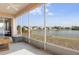 Screened patio features tranquil lake view, ceiling fan, and comfortable seating, blending indoor and outdoor living spaces at 416 Durham Shore Ct, Apollo Beach, FL 33572