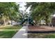 Charming playground with swings and slides, nestled among mature trees in a Gathering-friendly neighborhood at 416 Durham Shore Ct, Apollo Beach, FL 33572