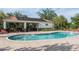 Community pool area with lounge chairs and shaded pavilion, perfect for relaxation at 416 Durham Shore Ct, Apollo Beach, FL 33572