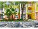 Exterior of a colorful condo building with lush landscaping and balconies and parking out front at 4207 S Dale Mabry Hwy # 12206, Tampa, FL 33611