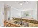 Kitchen featuring oak cabinetry, granite countertops, double sink, and a view into the living room at 4207 S Dale Mabry Hwy # 12206, Tampa, FL 33611