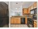 Bright kitchen showcasing wood cabinets, granite countertops, tile backsplash, and stainless steel appliances at 4207 S Dale Mabry Hwy # 12206, Tampa, FL 33611