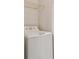 White washing machine with top-mounted controls and a wire shelf above provides a clean and organized laundry solution at 4207 S Dale Mabry Hwy # 12206, Tampa, FL 33611