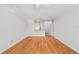 Living room featuring hardwood floors, white walls, ceiling fan, and open to the kitchen area at 4207 S Dale Mabry Hwy # 12206, Tampa, FL 33611