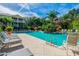 Scenic swimming pool with sun loungers, palm trees, and a tranquil waterfall feature for relaxation at 4207 S Dale Mabry Hwy # 12206, Tampa, FL 33611