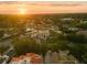 Beautiful aerial view of a neighborhood with a modern house, lush trees, and a stunning sunset at 4300 Bayshore Ne Blvd, St Petersburg, FL 33703