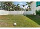 A soccer net and ball sit ready for a game in this grassy, fenced backyard at 4300 Bayshore Ne Blvd, St Petersburg, FL 33703