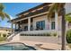 A modern home's covered patio overlooks the pool and lush landscaping, perfect for relaxing at 4300 Bayshore Ne Blvd, St Petersburg, FL 33703