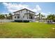 Expansive backyard featuring a lush lawn and a modern white home with a covered patio at 4300 Bayshore Ne Blvd, St Petersburg, FL 33703