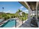 Balcony view showcasing a pool, manicured lawn, palm trees and patio seating, perfect for relaxing outdoors at 4300 Bayshore Ne Blvd, St Petersburg, FL 33703