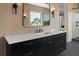 Bathroom vanity with modern fixtures, black cabinets and drawers, and beautiful lighting at 4300 Bayshore Ne Blvd, St Petersburg, FL 33703
