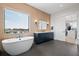 A luxurious bathroom with a freestanding tub, dual vanity, and walk-in closet at 4300 Bayshore Ne Blvd, St Petersburg, FL 33703