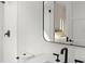 Elegant bathroom with a modern sink, mirror, and textured white tile walls at 4300 Bayshore Ne Blvd, St Petersburg, FL 33703