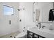 Modern bathroom with a glass-enclosed shower, sleek fixtures, and textured white tile at 4300 Bayshore Ne Blvd, St Petersburg, FL 33703