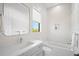 Bright bathroom featuring a tub, shower, modern vanity and a window with a view at 4300 Bayshore Ne Blvd, St Petersburg, FL 33703