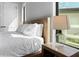 Close-up on a serene bedroom with a wood bed frame and bright natural light at 4300 Bayshore Ne Blvd, St Petersburg, FL 33703