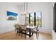 Bright dining room with modern light fixture, large window, and neutral-toned dining chairs at 4300 Bayshore Ne Blvd, St Petersburg, FL 33703