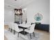 Bright dining room featuring a modern light fixture, a marble-top table, and sleek sideboard at 4300 Bayshore Ne Blvd, St Petersburg, FL 33703