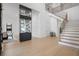 Bright foyer with a glass wine display and an elegant staircase at 4300 Bayshore Ne Blvd, St Petersburg, FL 33703